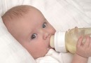 Six month old baby boy drinking his bottle