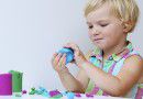 child_girl_playing_playdoh_plastiline_creating_art