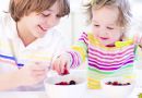 Kids eating fruit and cereal