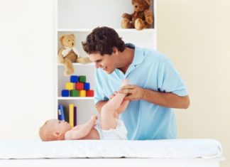 Father changing baby