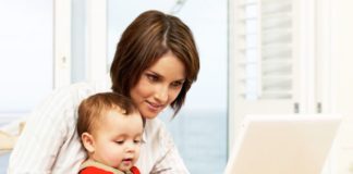 Mother with baby on laptop.