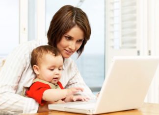 Mother with baby on laptop.