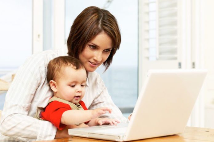 Mother with baby on laptop.