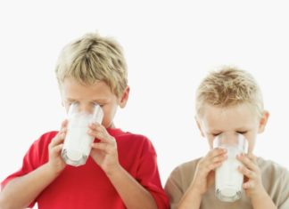 Two blond boys drinking milk